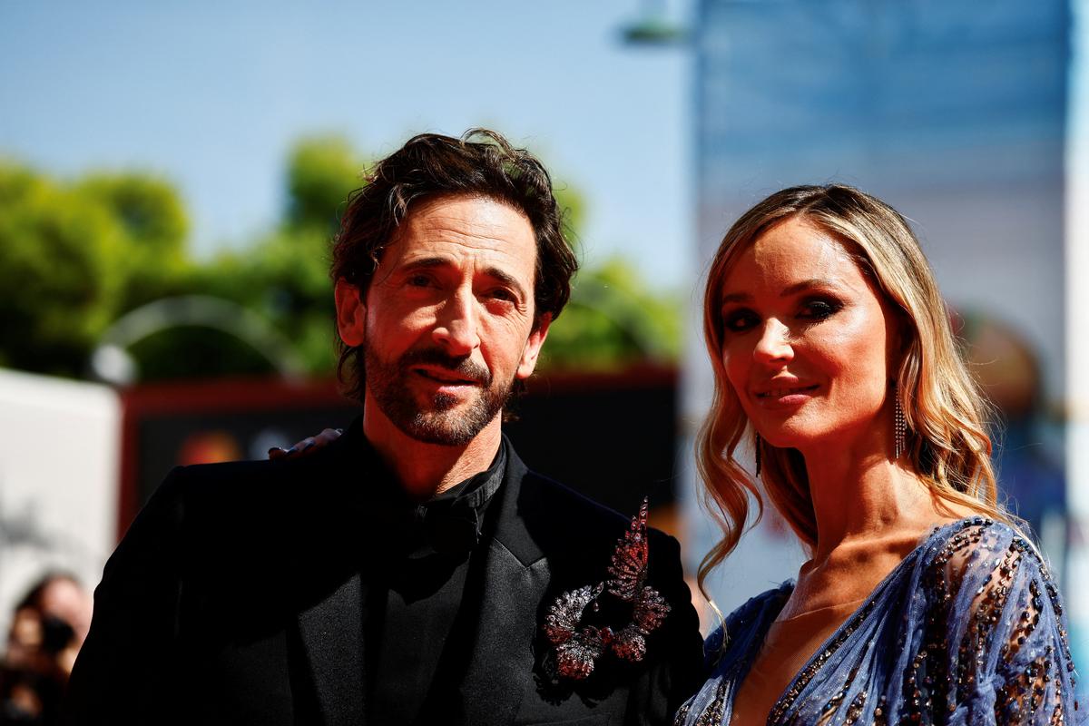 Cast members Adrien Brody and Georgina Chapman pose on the red carpet during arrivals for a screening of 'The Brutalist' in competition at the 81st Venice Film Festival, Venice, Italy, September 1, 2024. 