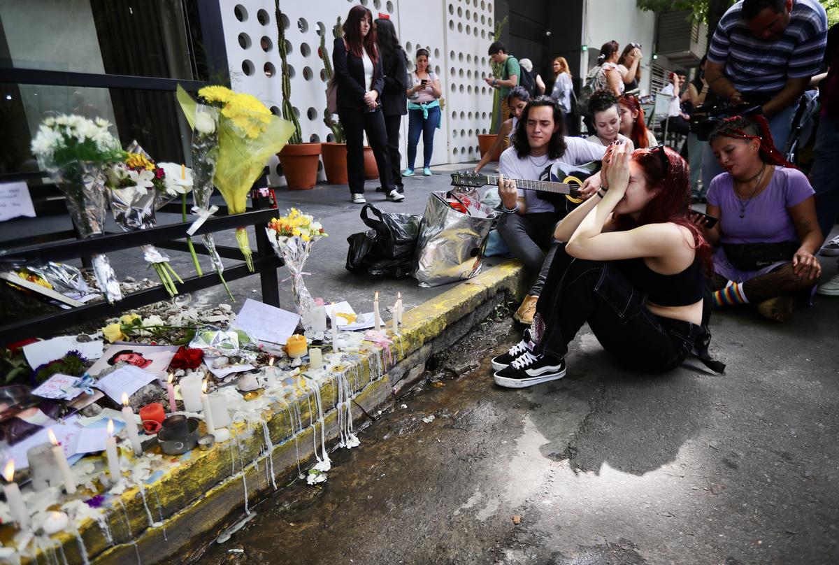 Fans mourn at a memorial for former One Direction singer Liam Payne after his death outside the Casa Sur Hotel on October 17, 2024 in Buenos Aires, Argentina.