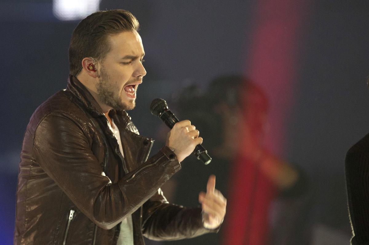 FILE - This is a Friday, Dec. 12, 2014 file photo of One Direction singer Liam Payne as he performs on stage with the group during the '40 Principals Awards 2014' ceremony at the Palacio de los Deportes in Madrid, Spain.